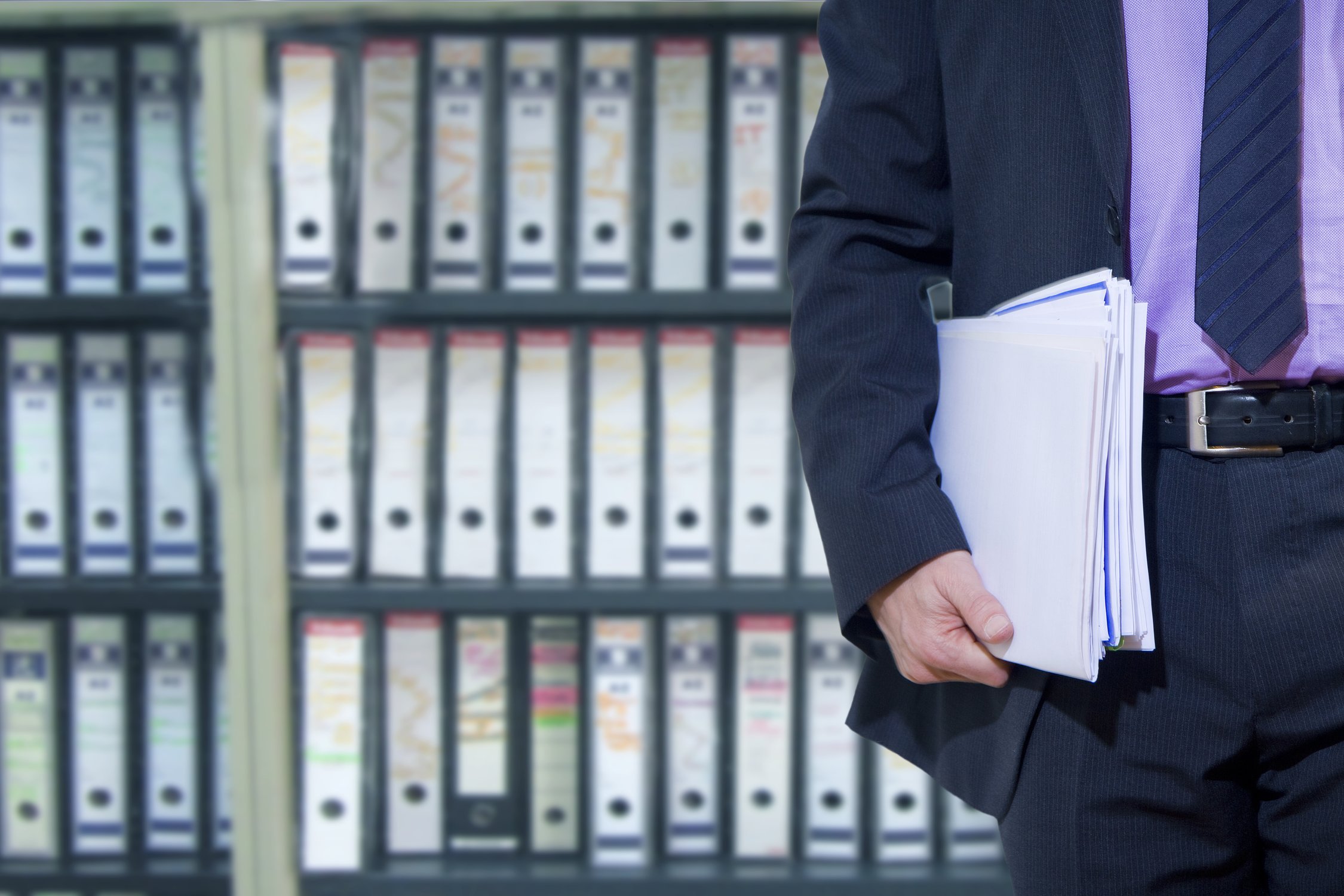 businessman-carrying-documents-in-a-filing-cabinet