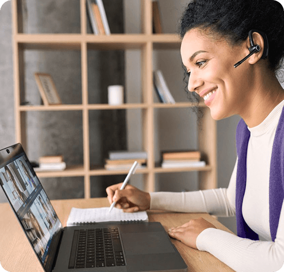 A woman with headphones is working on her laptop